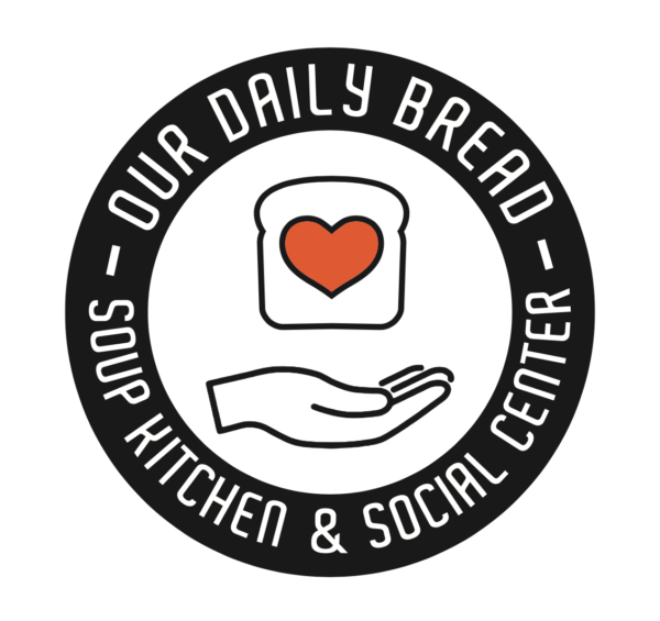Round button with a piece of bread with a heart in the center above an open hand- around the outside, the pin reads Our Daily Bread Soup Kitchen and Social Center